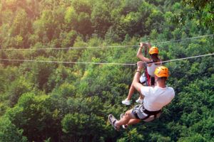 person ziplining in the mountains